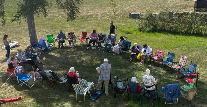 church bqq, everyone sitting in chairs eating.