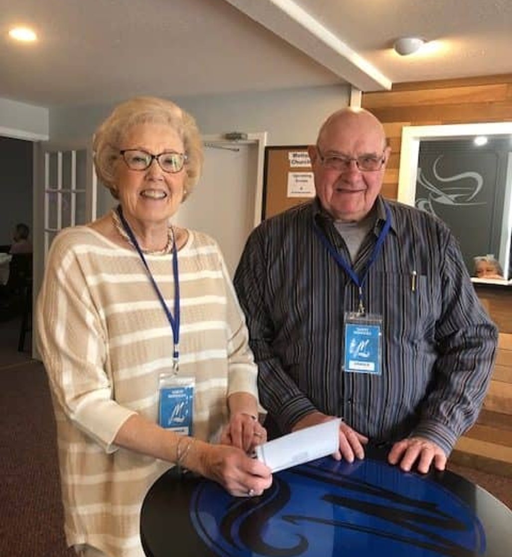 Morning Greeters handing shaking guest at Motion Church